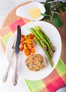 Meat rissole with glazed carrots, asparagus on the plate. Royalty Free Stock Photo