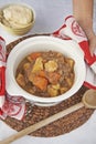 Meat and roasted vegetable stew served in crock pot