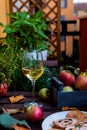 Meat roll filled with pistachios and prunes, white wine glass on rustic wooden table