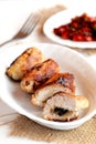 Meat rolls with mushrooms. Roasted Turkey breast rolls with mushrooms on the plate and on the burlap, fork, vegetable salad Royalty Free Stock Photo