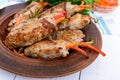 Meat rolls stuffed with sweet pepper, carrots in a clay bowl on a white wooden background. Royalty Free Stock Photo