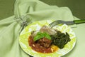 Meat rolls in tomato sauce served with spinach Royalty Free Stock Photo