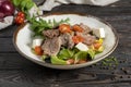 Meat salad with roast beef and feta cheese. Cold appetizer of lettuce leaves, cherry tomatoes, beef, veal or pork, feta cheese and Royalty Free Stock Photo