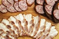 Meat and sausage for sandwiches on a wooden board. Fatty bacon for breakfast. Close-up