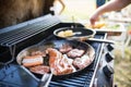 Meat and sausages on the grill. Garden party outside in the backyard. Royalty Free Stock Photo