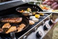 Meat and sausages on the grill. Garden party outside in the backyard. Royalty Free Stock Photo