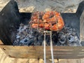 Meat sausages in a natural casing are grilled on coals in a moghal in the fresh air. overall plan Royalty Free Stock Photo