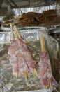 Meat sausages on wooden skewers in ÃÂ°luminium packaging and cellophane