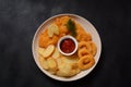 Meat schnitzel and fried potatoes with onion rings deep fried Royalty Free Stock Photo