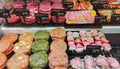 Meat section with fresh beef and chicken chops, skewers with vegetables