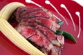 Meat served on red with corns Royalty Free Stock Photo