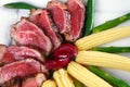 Meat served on white with corns Royalty Free Stock Photo