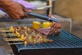 Meat and skewers ingredients for barbecue party are placed on grill to cook barbecue and make it ready for family to join barbecue Royalty Free Stock Photo