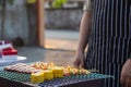 Meat and skewers ingredients for barbecue party are placed on grill to cook barbecue and make it ready for family to join barbecue Royalty Free Stock Photo