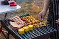 Meat and skewers ingredients for barbecue party are placed on grill to cook barbecue and make it ready for family to join barbecue