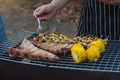 Meat and skewers ingredients for barbecue party are placed on grill to cook barbecue and make it ready for family to join barbecue Royalty Free Stock Photo