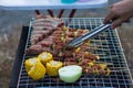 Meat and skewers ingredients for barbecue party are placed on grill to cook barbecue and make it ready for family to join barbecue Royalty Free Stock Photo