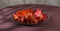 meat slices on a plate. traditional spanish sausage with beef jerky. salchichon, chorizo and prosciutto Royalty Free Stock Photo