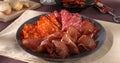 meat slices on a plate. traditional spanish sausage with beef jerky. salchichon, chorizo and prosciutto Royalty Free Stock Photo