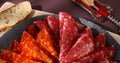 meat slices on a plate. traditional spanish sausage with beef jerky. salchichon, chorizo and prosciutto Royalty Free Stock Photo