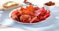 meat slices on a plate. traditional spanish sausage with beef jerky. salchichon, chorizo and prosciutto Royalty Free Stock Photo