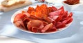 meat slices on a plate. traditional spanish sausage with beef jerky. salchichon, chorizo and prosciutto Royalty Free Stock Photo