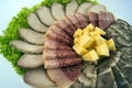 Meat slicing. Sausage, meat, roll and cheese decorated with lettuce leaves