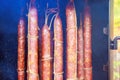 Meat of smoked sausages hangs in a traditional smokehouse after being smoked.