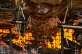 Meat Spit Roasting over the Flames of a log fire Royalty Free Stock Photo