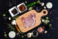 Meat steak on a cutting board and pepper, bay leaf, rosemary, onions, salt, olive oil, soy sauce Royalty Free Stock Photo