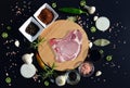 Meat steak on a cutting board and pepper, bay leaf, rosemary, onions, salt, olive oil, soy sauce Royalty Free Stock Photo