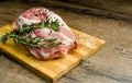 Meat for steak with rosemary on a wooden board Royalty Free Stock Photo