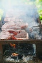 Meat steaks on a grill rack cooking over an open fire