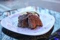 Meat steaks, pork, beef on a white plate on a table in a cafe, restaurant in the evening.