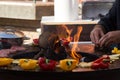 Meat, steaks and sausages with vegetables cooking on grill and smoldering coals. Barbecue Royalty Free Stock Photo