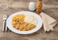 Meat strogonoff with rice and straw potato over wooden table Royalty Free Stock Photo