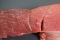 Raw meat, beef. Piece of raw meat on a gray background. Royalty Free Stock Photo