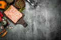 Meat stuffing with spices and herbs on a wooden board. Royalty Free Stock Photo