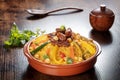 Meat and vegetable couscous, traditional Moroccan food, with fresh herbs