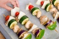 Meat and vegetable kabobs on baking tray