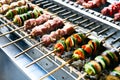 Meat and vegetable kebabs on skewers over coals on barbecue. BBQ grilled shish meat on skewers. Grilling pork or beef Royalty Free Stock Photo