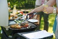 Meat and vegetables grilling on outdoor grill. Outdoor grill or BBQ party in the garden. Royalty Free Stock Photo