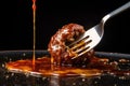 meatball on a fork with sauce dripping