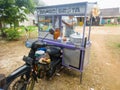 the meatball seller sells his wares using a motorbike