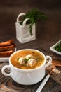 meatball soup. white broth on a wooden stand with delicious noodle soup with meatballs