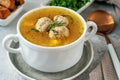 meatball soup. white broth on a wooden stand with delicious noodle soup with meatballs