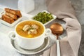 meatball soup. white broth on a wooden stand with delicious noodle soup with meatballs