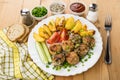 Meatballs with baked potatoes, tomatoes, cucumbers and green onion Royalty Free Stock Photo