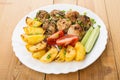 Meatballs with baked potatoes, tomatoes, cucumbers and green onion Royalty Free Stock Photo