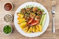 Meatballs with baked potatoes, tomatoes, cucumbers. Green onion, ketchup Royalty Free Stock Photo